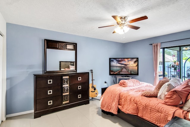 bedroom with ceiling fan, a textured ceiling, access to outside, and baseboards