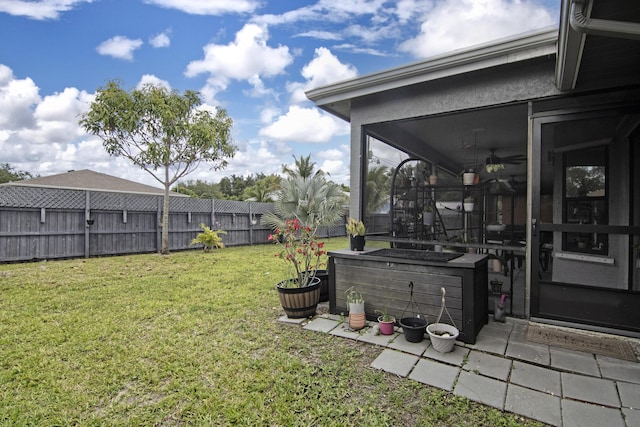 view of yard featuring a fenced backyard and a sunroom