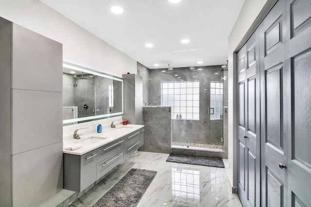 bathroom featuring a sink, marble finish floor, recessed lighting, a shower stall, and double vanity