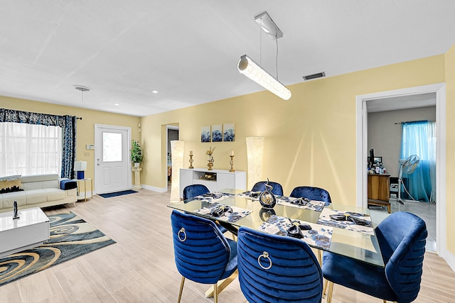 dining area with baseboards, recessed lighting, and wood finished floors
