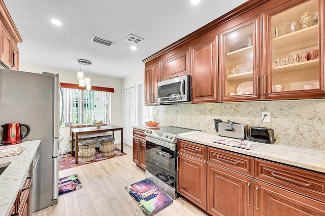 kitchen with appliances with stainless steel finishes, backsplash, light stone counters, light wood-type flooring, and recessed lighting