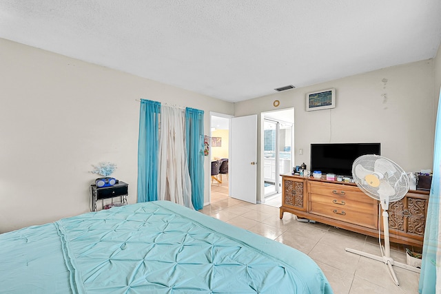 bedroom featuring tile patterned floors and a textured ceiling