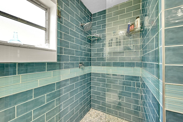 bathroom with a tile shower