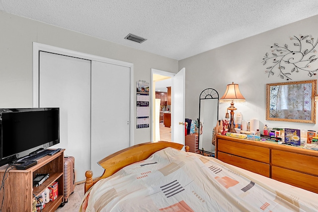 bedroom featuring a closet and a textured ceiling