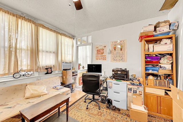 office space featuring a textured ceiling and a ceiling fan