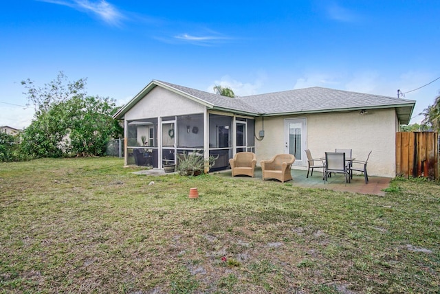back of property featuring stucco siding, a sunroom, a patio area, and roof with shingles