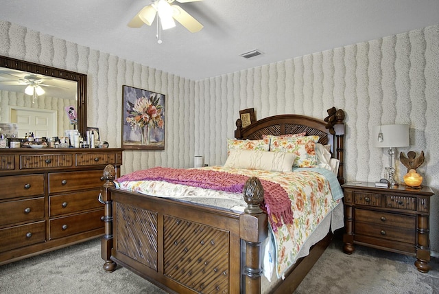 bedroom featuring carpet, wallpapered walls, and a ceiling fan