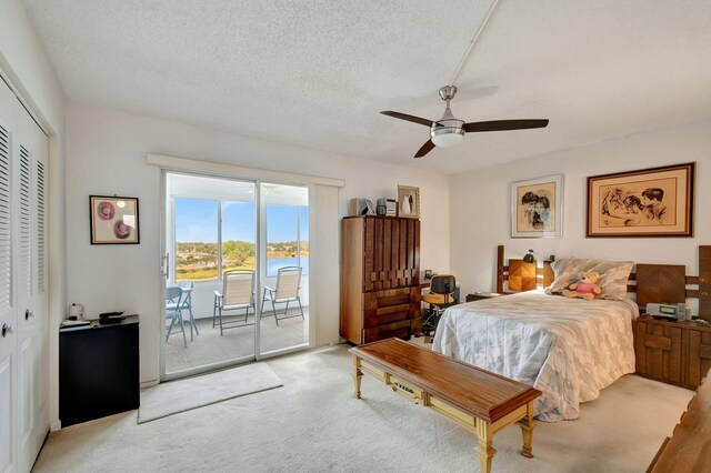 bedroom featuring light colored carpet, access to exterior, a closet, and ceiling fan