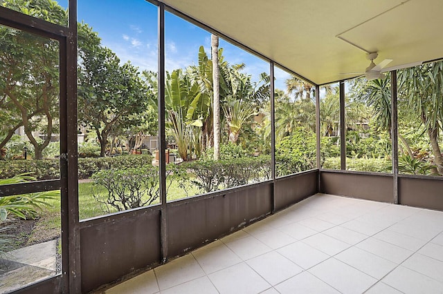unfurnished sunroom with ceiling fan
