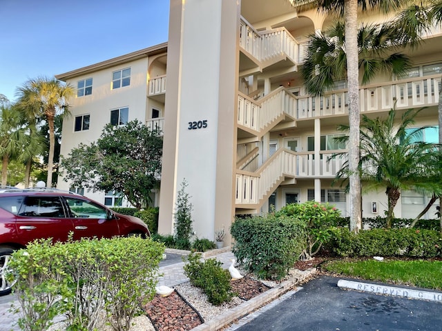 view of apartment building / complex with uncovered parking