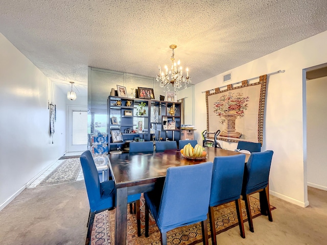 carpeted dining space with a chandelier, a textured ceiling, and baseboards