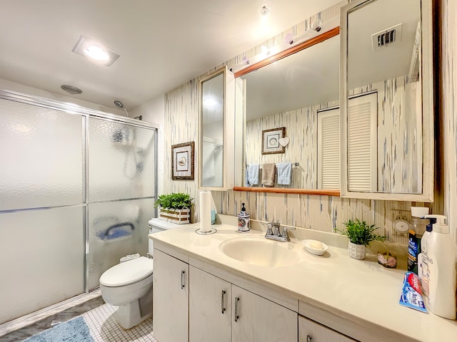 full bathroom with a stall shower, toilet, and vanity