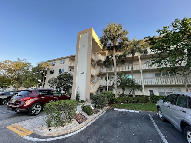 view of building exterior featuring uncovered parking