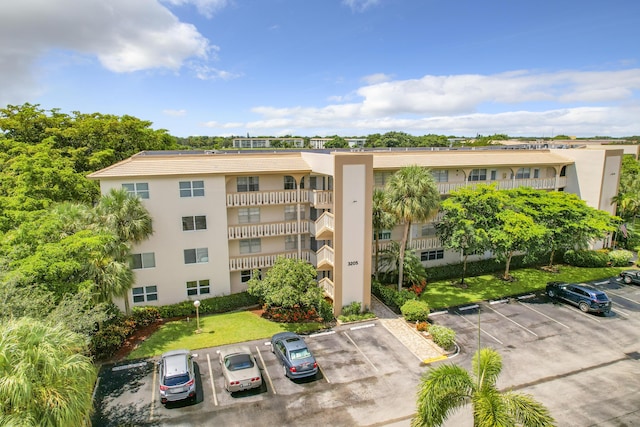 view of property featuring uncovered parking