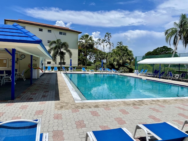 community pool featuring a patio and fence