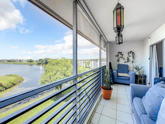 sunroom featuring a water view