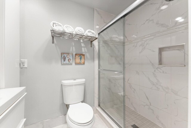 full bath with a shower stall, toilet, baseboards, and vanity