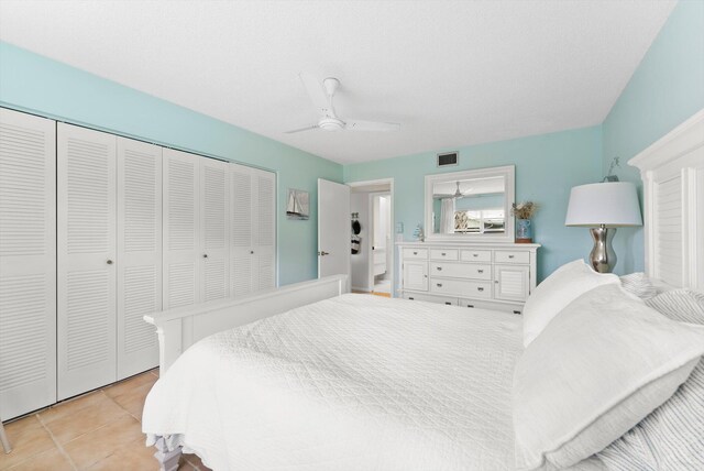 bedroom with a closet, light tile patterned floors, and a ceiling fan