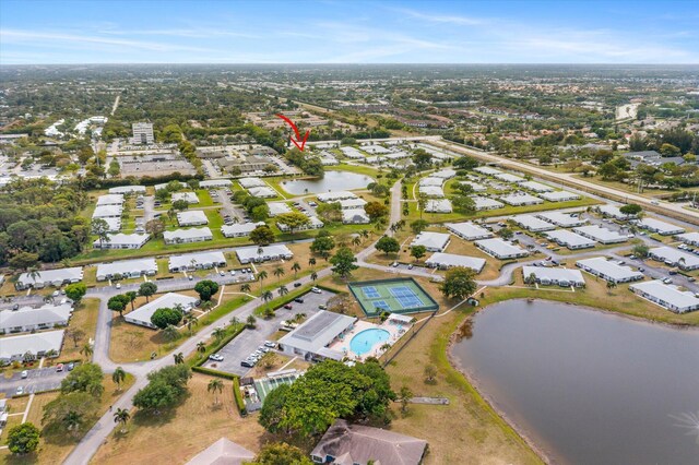 aerial overview of property's location with a nearby body of water and nearby suburban area