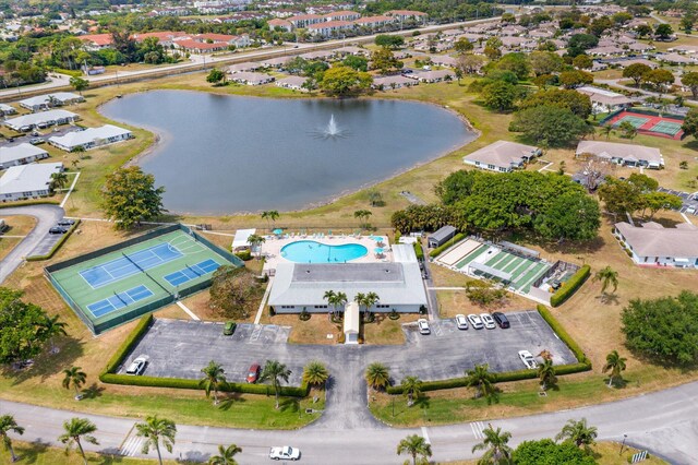 view of property location with a nearby body of water and a pool area