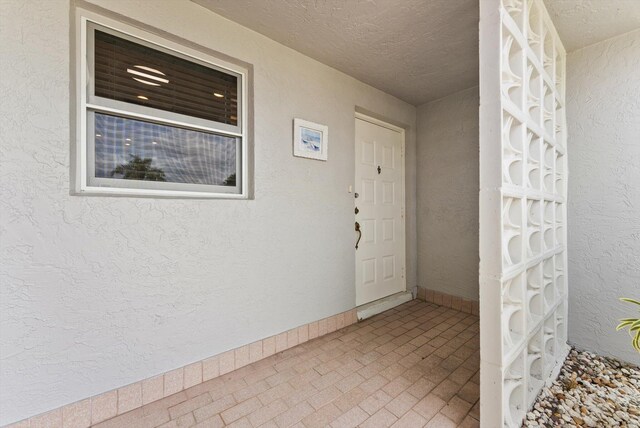 property entrance with stucco siding