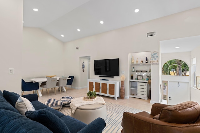 living area with light wood-style flooring, high vaulted ceiling, a dry bar, and recessed lighting