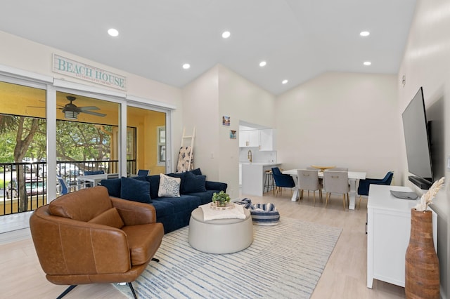 living room with high vaulted ceiling, light wood-style floors, a ceiling fan, and recessed lighting