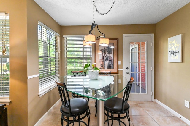 1125 Crystal Way Unit I, Delray Beach, FL 33444 - dining space with light tile patterned floors, a textured ceiling, and baseboards