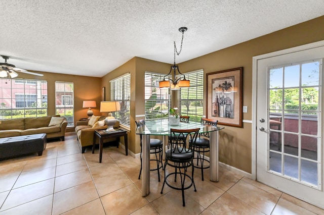 1125 Crystal Way Unit I, Delray Beach, FL 33444 - dining area featuring a textured ceiling, baseboards, light tile patterned floors, and ceiling fan