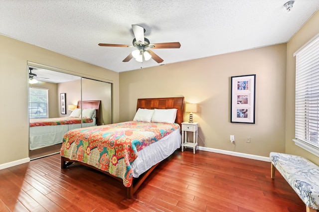 1125 Crystal Way Unit I, Delray Beach, FL 33444 - bedroom with wood finished floors, a closet, multiple windows, and a textured ceiling