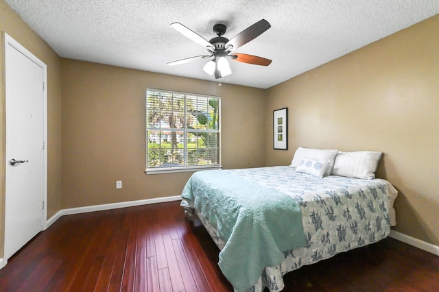 1125 Crystal Way Unit I, Delray Beach, FL 33444 - bedroom featuring baseboards, dark wood-style floors, a textured ceiling, and a ceiling fan