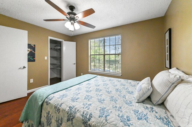 1125 Crystal Way Unit I, Delray Beach, FL 33444 - bedroom featuring wood finished floors, a textured ceiling, ceiling fan, baseboards, and a spacious closet