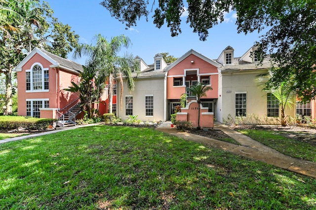 1125 Crystal Way Unit I, Delray Beach, FL 33444 - view of front of home with stucco siding, a front lawn, and stairs