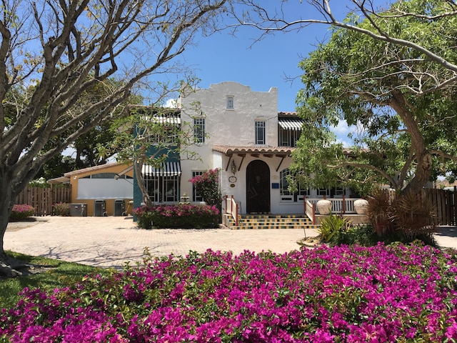 1125 Crystal Way Unit I, Delray Beach, FL 33444 - mediterranean / spanish-style home with stucco siding, a tiled roof, fence, and central air condition unit