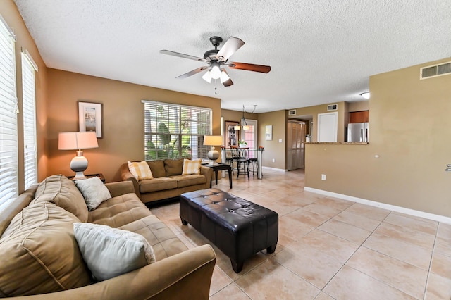 1125 Crystal Way Unit I, Delray Beach, FL 33444 - living area featuring a textured ceiling, a ceiling fan, light tile patterned floors, and baseboards