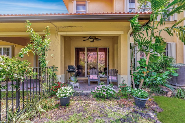 5742 NW 119th Ter, Coral Springs, FL 33076 - view of exterior entry with stucco siding and a ceiling fan