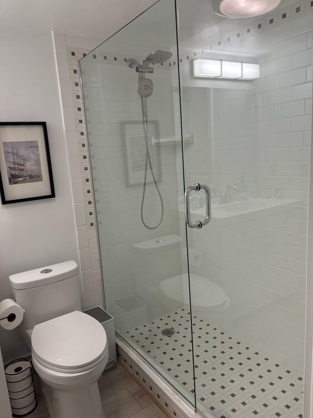 full bath featuring toilet and a stall shower