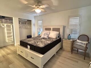 bedroom with light wood-style floors and ceiling fan