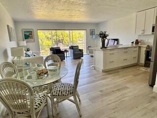 dining space with light wood-style floors
