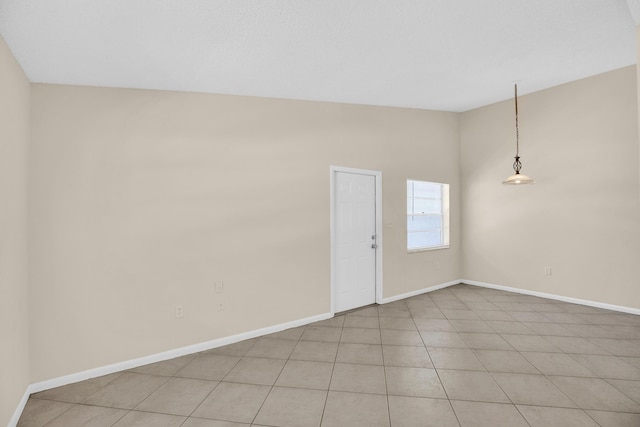 2015 Oleander Blvd Unit A, Fort Pierce, FL 34950 - unfurnished room featuring baseboards, vaulted ceiling, and light tile patterned floors