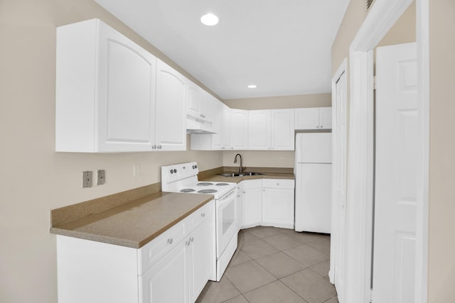 2015 Oleander Blvd Unit A, Fort Pierce, FL 34950 - kitchen with white appliances, under cabinet range hood, a sink, white cabinets, and recessed lighting