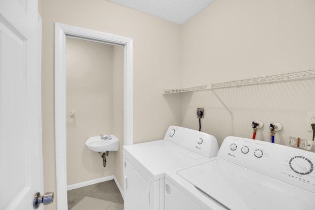 2015 Oleander Blvd Unit A, Fort Pierce, FL 34950 - laundry room featuring independent washer and dryer, light tile patterned floors, and baseboards