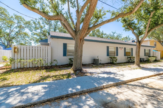 2015 Oleander Blvd Unit A, Fort Pierce, FL 34950 - view of front facade featuring brick siding, cooling unit, and fence