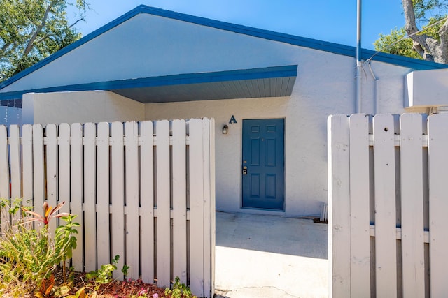 2015 Oleander Blvd Unit A, Fort Pierce, FL 34950 - entrance to property featuring stucco siding, fence, and a gate