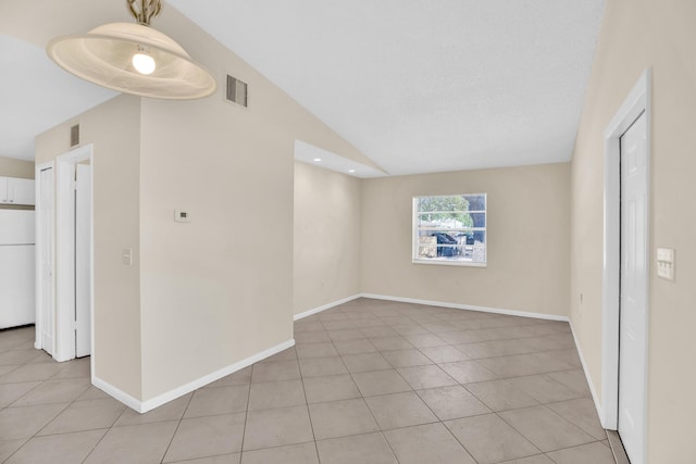 2015 Oleander Blvd Unit A, Fort Pierce, FL 34950 - unfurnished room with light tile patterned floors, vaulted ceiling, and baseboards