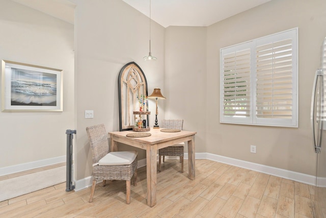 dining area with baseboards and wood finished floors