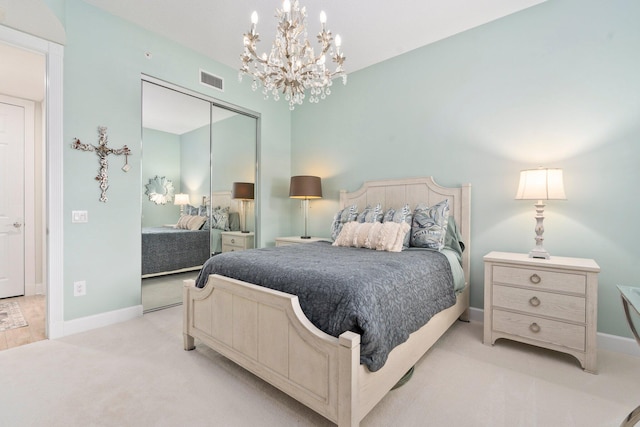 bedroom with a closet, visible vents, baseboards, and a notable chandelier
