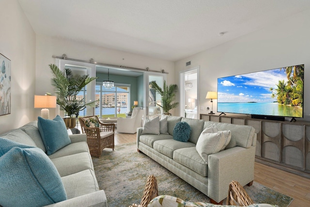 living room with visible vents and wood finished floors