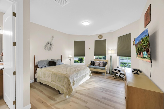 bedroom featuring visible vents and light wood-style flooring