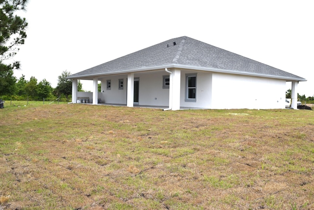 15722 NW 270th St, Okeechobee, FL 34972 - rear view of house featuring a lawn, stucco siding, and roof with shingles